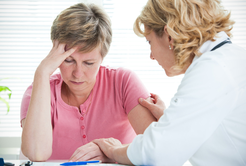 A woman is talking to a doctor about her health.