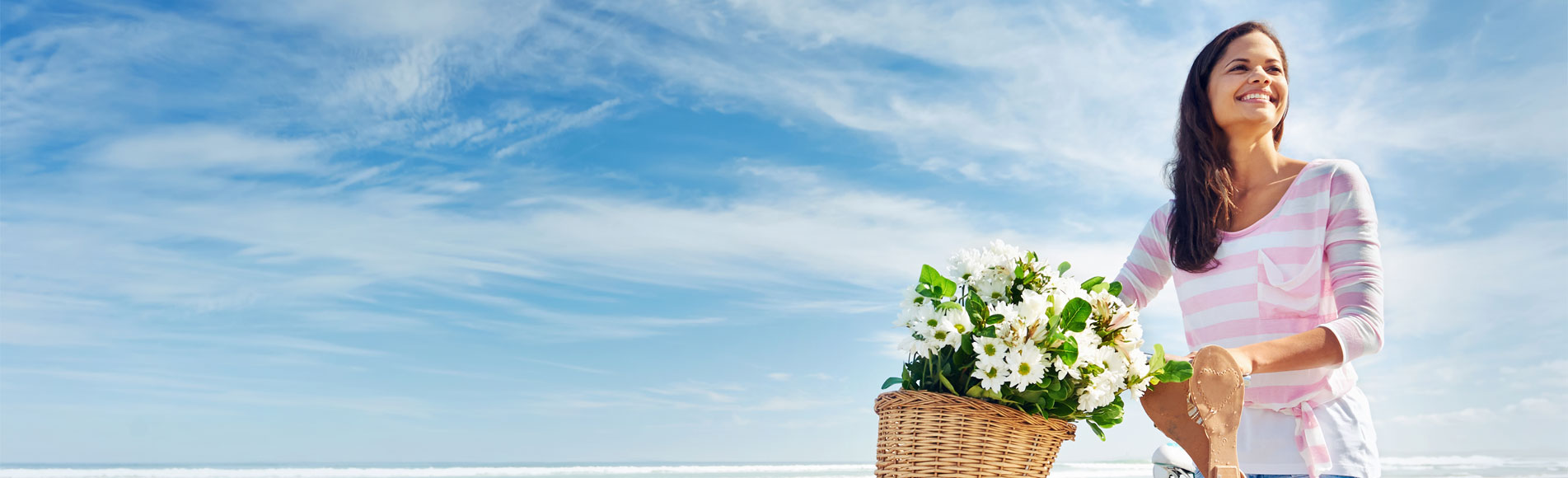 A basket of flowers against a blue sky.